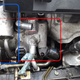 In red: the ABC pump, fully detached. In blue: a tiny muffler-thing attached to the A/C system, with a stranglehold on the hydraulic pump.